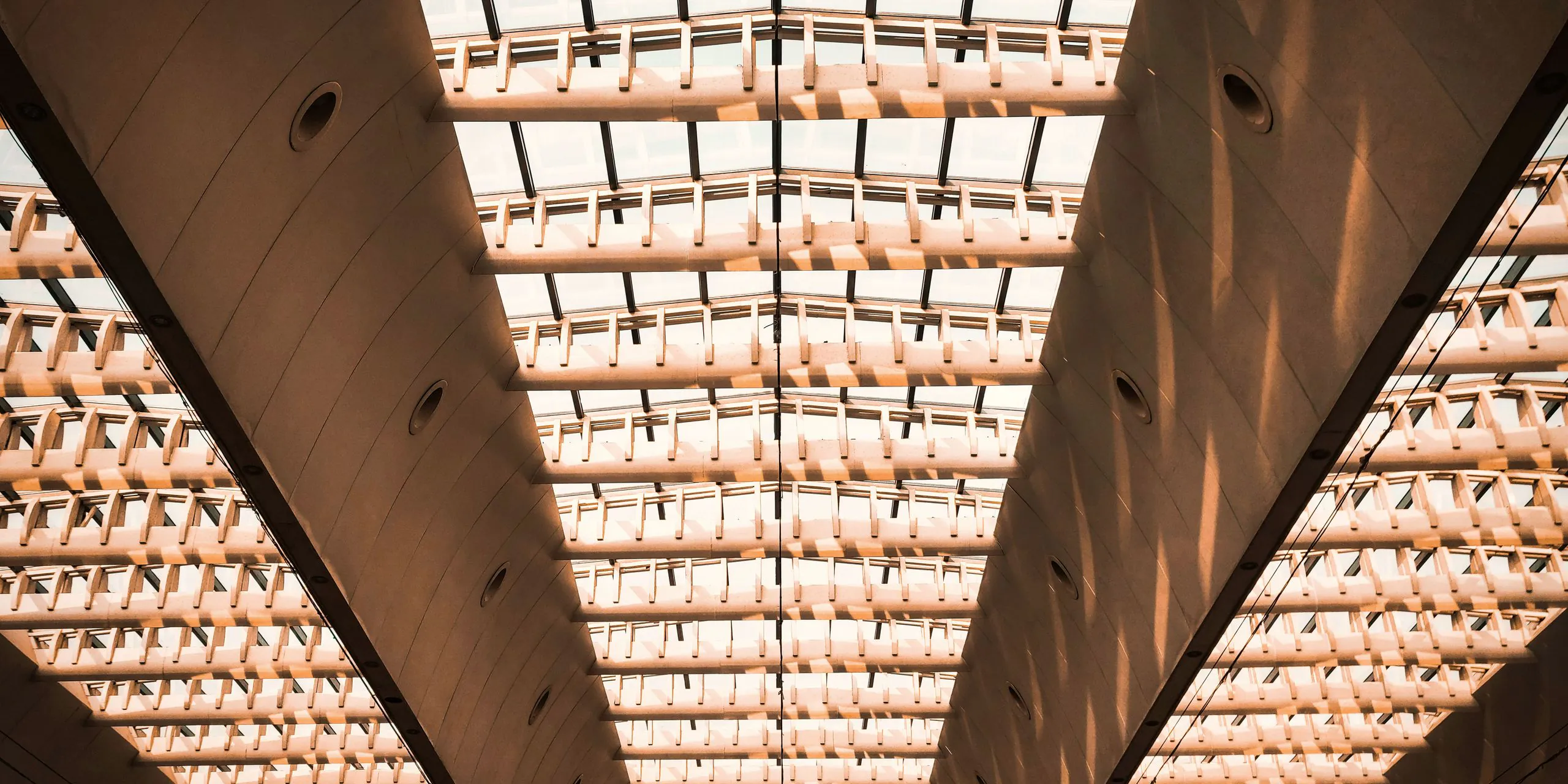Glass roof filled with light, seen from below