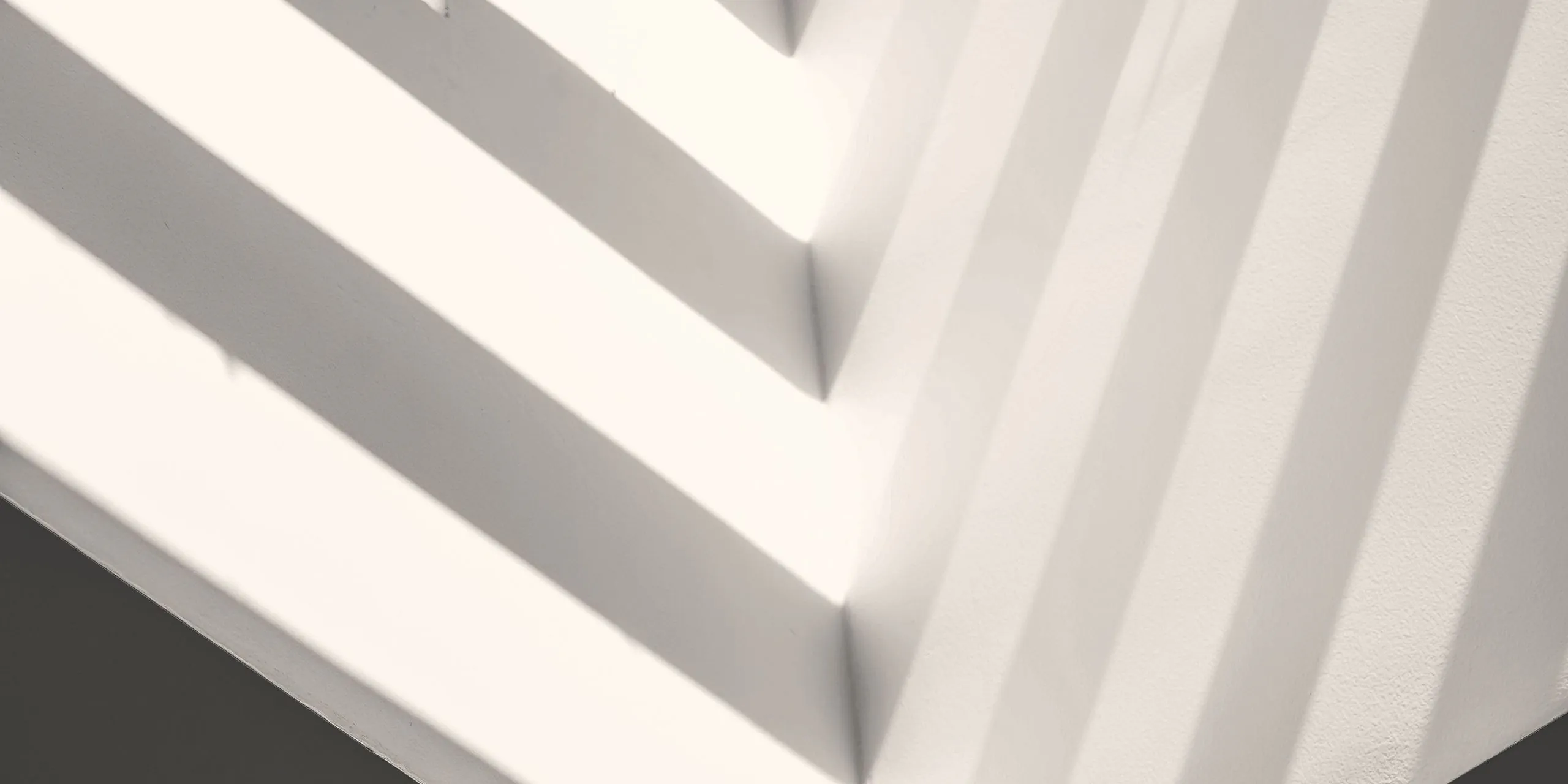 White architectural composition with geometric lines and shadows